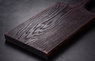 An empty plate with a knife, fork or spoon with a wooden cutting board