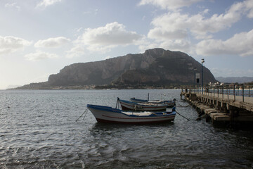 Fototapeta premium evocative image of fishing boats moored in the harbor in a small fishing village in Sicily, Italy 