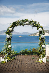 Wedding arch on the background of the sea and islands