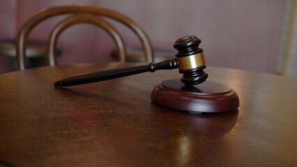 Lawyer or judge's hammer in the court. Auction's hammer is on woo table. Law subject.