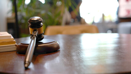 Lawyer or judge's hammer in the court. Auction's hammer is on woo table. Law subject.