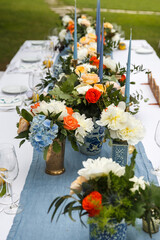 Bouquets of flowers in vase on the wedding table