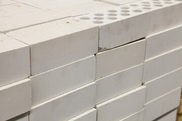 A lot new white silicate air bricks stack close up. Building materials production storage and retail.