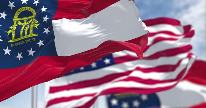 Seamless loop in slow motion with two Georgia state flags waving along with the national flag of the United States of America