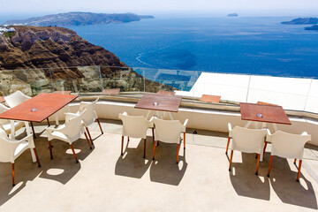 View of the Aegean sea from Santorini island with table and seats in the foreground, Greece. Greek...