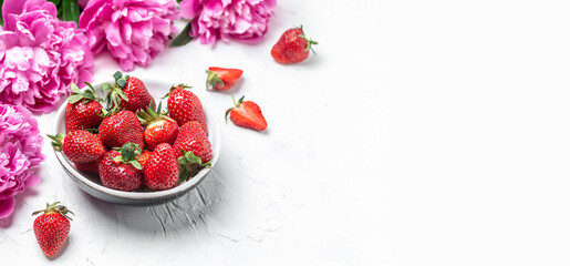 Sweet fresh strawberries with peony rose on a white background. Banner, flyer, beautiful postcard,...