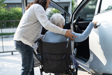 Asian senior or elderly old lady woman patient sitting on wheelchair prepare get to her car, healthy strong medical concept.