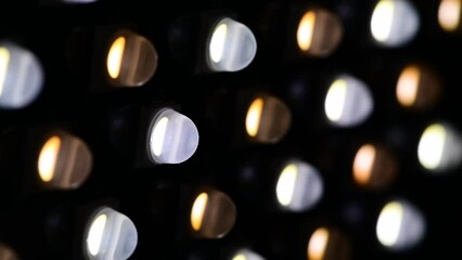 Bright white and yellow illuminated LED close up abstract background, black screen, lights on and lights off