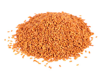 Camelina sativa seeds isolated on white background. Seeds of camelina or false flax. Raw material for the production of camelina oil.