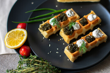 black caviar on a waffle serving on the table