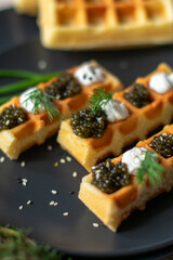 black caviar on a waffle serving on the table
