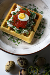 red caviar on a waffle, breakfast serving
