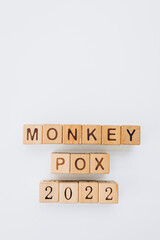 MONKEYPOX. Word written on square wooden tiles with an white background. Zoonotic viral disease that can infect non-human primates, rodents and some other mammals. Smallpox. Monkey pox. Virus.