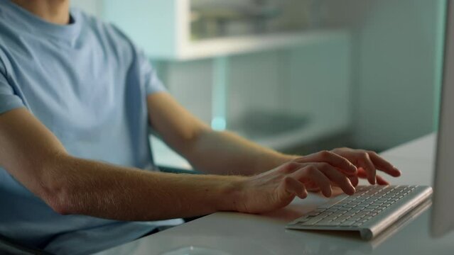 Closeup hands typing computer keyboard. Focused man writing email at home office