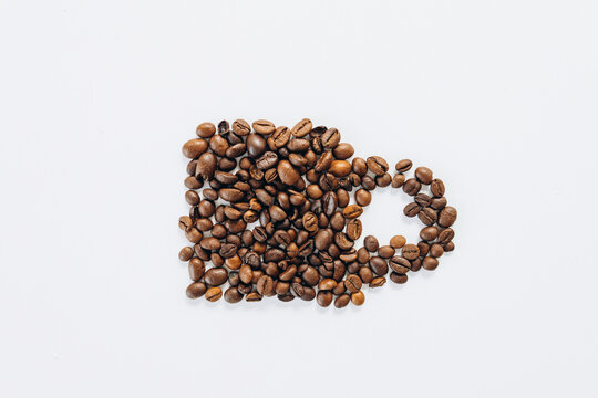 Cup made on coffee beans on white background