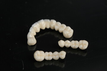 Metal free ceramic dental crowns. Dental ceramic bridge on isolated wite background