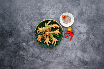 Steamed Chicken Feet with spring onion, garlic and fish sauce served in bowl isolated on dark grey background top view of japanese food