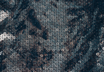 Fabric Silver texture with spangles. Background sequin. Glitter texture. Fabric sequins. Iron cloth. Sequins pattern. Abstract background. Metal structure. Dark thing. Black cloth.