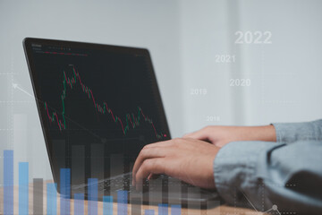 Market planning, stock market investing when hoping to make a profit A businessman uses a laptop to analyze stocks. Red and green bar charts and trading techniques to determine success.