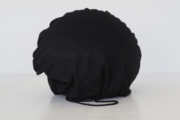 Motorcycle helmet in black cover.