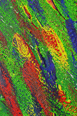 Creative background of colorful brush strokes on canvas closeup. Abstract art background from smeared brush strokes of green red blue yellow colors macro. Drawing painting paint texture backdrop