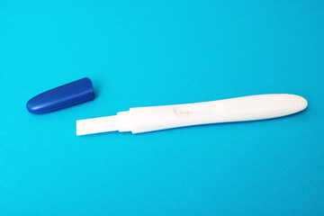 Positive pregnancy test on a blue background