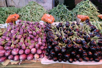 Stacks of pink and purple eggplants at a market stall in Amman, Jodan