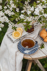 English tea in spring blossom garden. Vertical