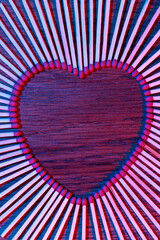Matches on a wooden background form abstract heart. Neon light. Copy space for text. Passionate hot...