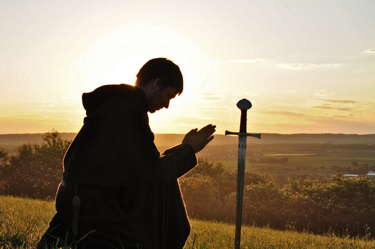 Knight Kneeling Down And Praying To A Sword In The Evening Before The Battle, Sunset Background, Knight Prayer, Vigil