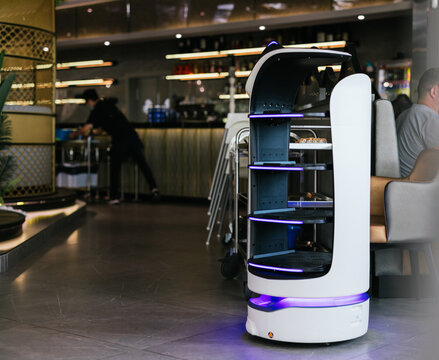 Robot Waiter Serving Food In A Restaurant