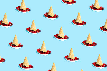 Paper boats filled with ripe cherries on pastel blue background. Minimal summer vacation concept. Seamless pattern, isometric view.