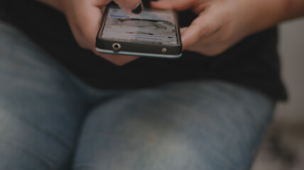 Woman with black nails, Seeing a photo of a pregnant woman, interacting in social networks, on her cell phone.