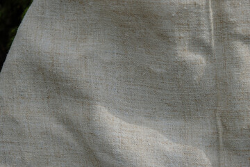 Hemp fabric or hemp canvas. Sustainable and environmentally friendly textile. Sunlight. Copy space.	