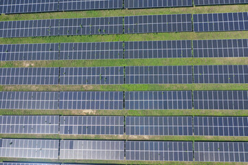Aerial view of Ecology solar power station panels in the fields green energy in sunny day,...