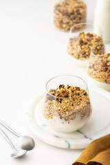 Homemade granola with almonds in a glass with yogurt, delicious healthy breakfast