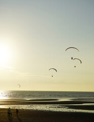 Silhouette of para gliding at sunset sky with sea background