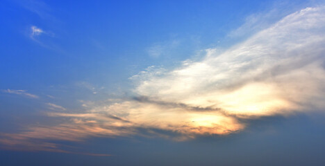 Naklejka na ściany i meble Dramatic sky background, Sunset shine behind clouds with blue sky background