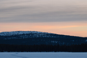 Fototapeta na wymiar stunning sunset orange sky above mountain in finnish lapland