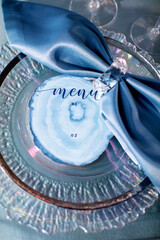 Cards with inscriptions on a plate on a wedding table