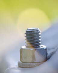 Close up view of nut and screw on sheet metal