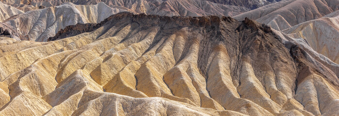 Panoramic view of Clay formations at Zabriskie point in death valley national park.