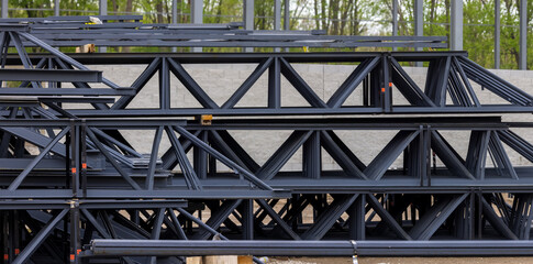 Close up view of structural steel for industrial building stacked and ready for construction.