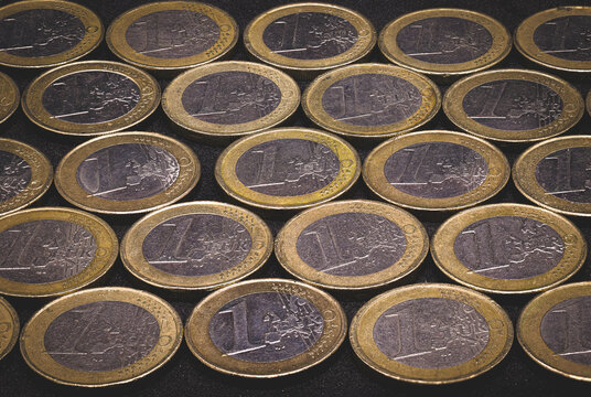 Many 1 Euro coins next to each other, as a sign of success and profit in the stock market, can also be used as a background image. 