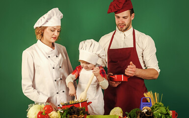 Cook at home. Mother, father and son prepare tasty food at kitchen. Family cooking together.