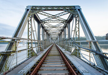 An old abandoned railway bridge during the sunset