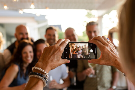 Woman photographing people on party