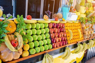 Juice bar and fruit shop stall at the city street. Retail small business and healthy beverage