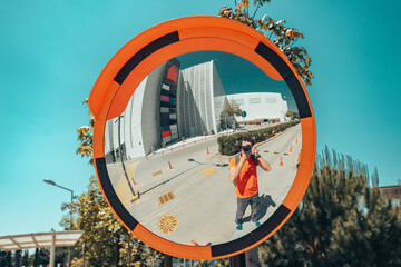 Self portrait of pedestrian in convex wide mirror. Safety for car traffic measures
