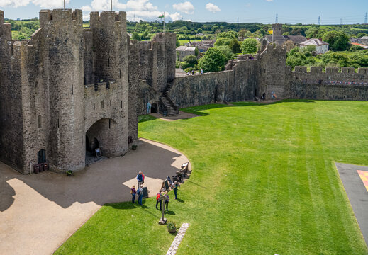 view from the top of 80 foot high keep at the stunning Pembroke Castle, looking over inner courtyard, blue sky background